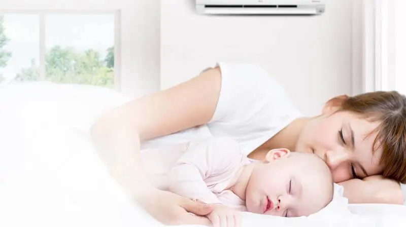 Mother and baby sleeping comfortably under AC - Delta Breeze